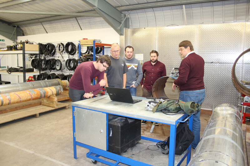 An employee of Oceaneering International, Inc. under the guidance of OKOndt GROUP specialist is trying to test a welded joint of a pipe using the wireless system TOFD-Man