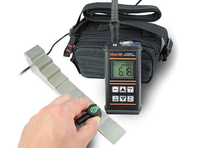 The ExScan1000 ultrasonic thickness gauge with a probe and calibration block